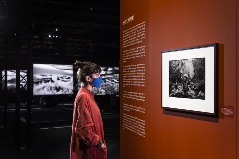 Woman looking at a photograph at the Amazonia exhibition at the Science and Industry Museum in Manchester