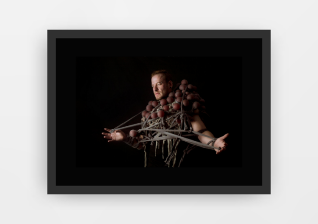 Photograph entitled 'A Tangled Mind' by artist Louisa Hammond, depicts a man wrapped in string and what looks like balloons