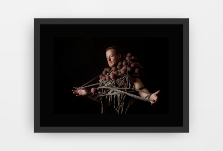 Photograph entitled 'A Tangled Mind' by artist Louisa Hammond, depicts a man wrapped in string and what looks like balloons