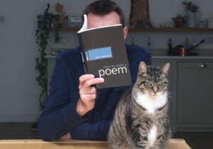 Brian Bilston reading his book 'How to Write A Poem' and a cat.
