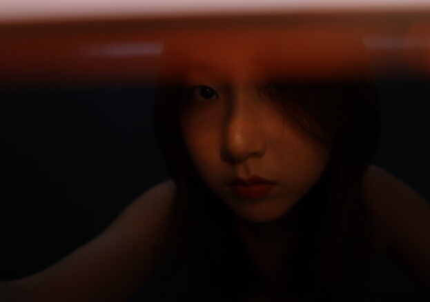 face of a woman in darkness