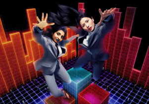 Two people in suits jumping in the air on a lit-up background