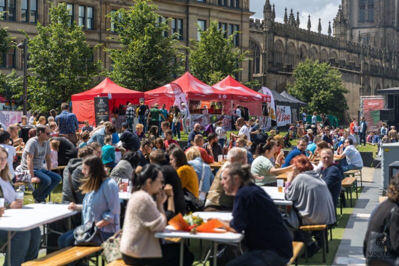 Festival goers eating food outdoors