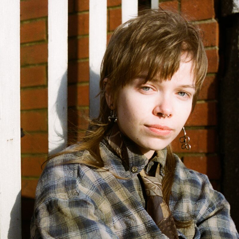 Photo of female in plaid shirt