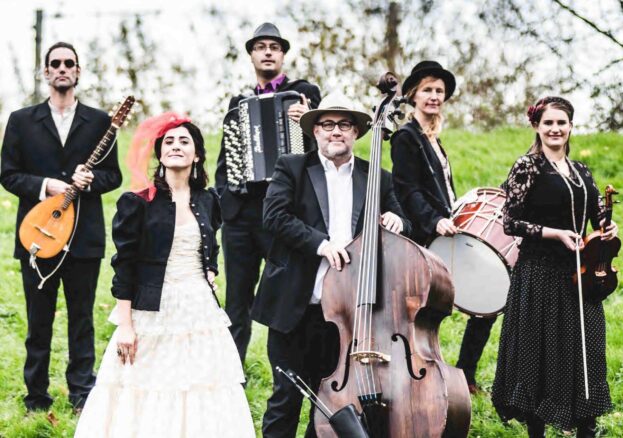 The band She'Koyokh with their instruments in a park