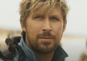 Close up of actor Ryan Gosling who frowns into the distance, hair tossled. 