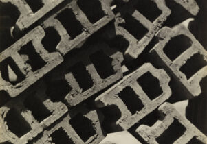 A black and white photograph of breezeblocks from above arranged to look like a street view from above