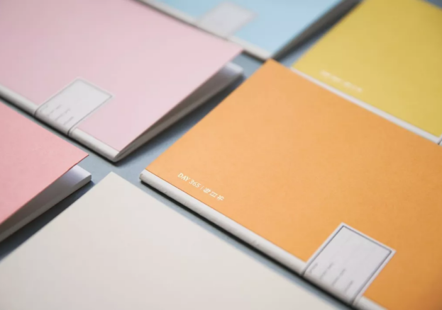 Colourful notebooks arranged around a table.