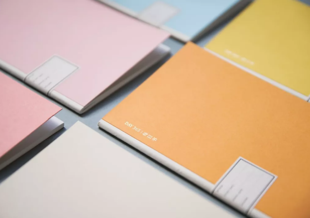 Colourful notebooks arranged around a table. 