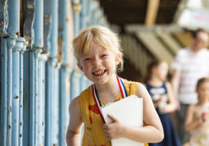 Grinning child on pool side