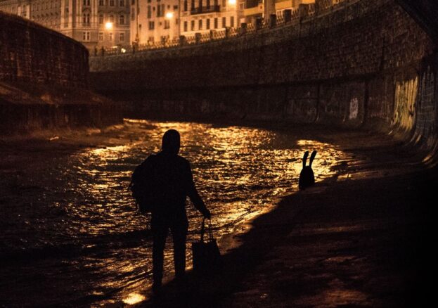 Nychos the street artist following the white rabbit down the Danube in Vienna