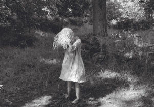 Unfolding Memory Exhibtion Poster, features a black and white image of a girl