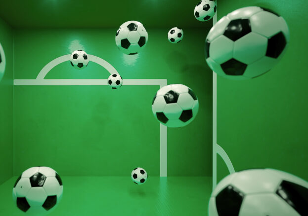 Multiple floating footballs inside a green room with white goalpost markings on the walls. The perspective and reflections create an illusion of depth, making it appear as if the balls are suspended in mid-air.