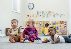 Three babies playing together in a Sure Start centre