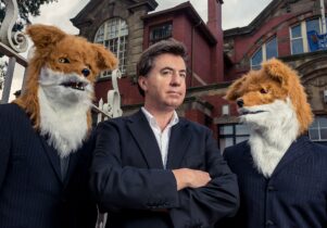 David Morley in a suit with two foxes wearing suits! 