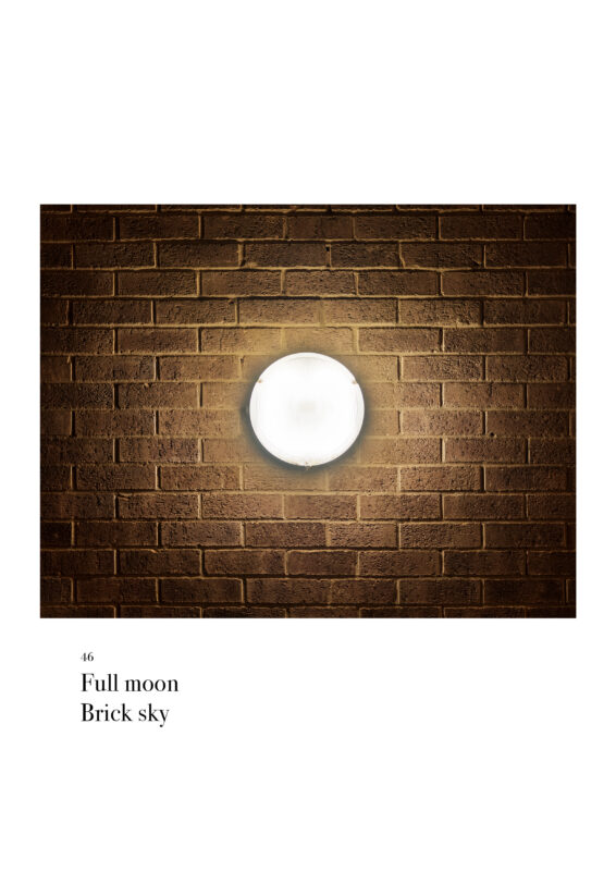 A round security light on a brick wall