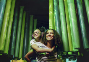 Mother and daughter wearing ear defenders in small intestine in Operation Ouch! Food, Poo and You Summer of senses at the Science and Industry Museum