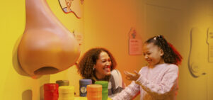 Mother and daughter play with smell interactive in Operation Ouch! Brains, Bogies and You