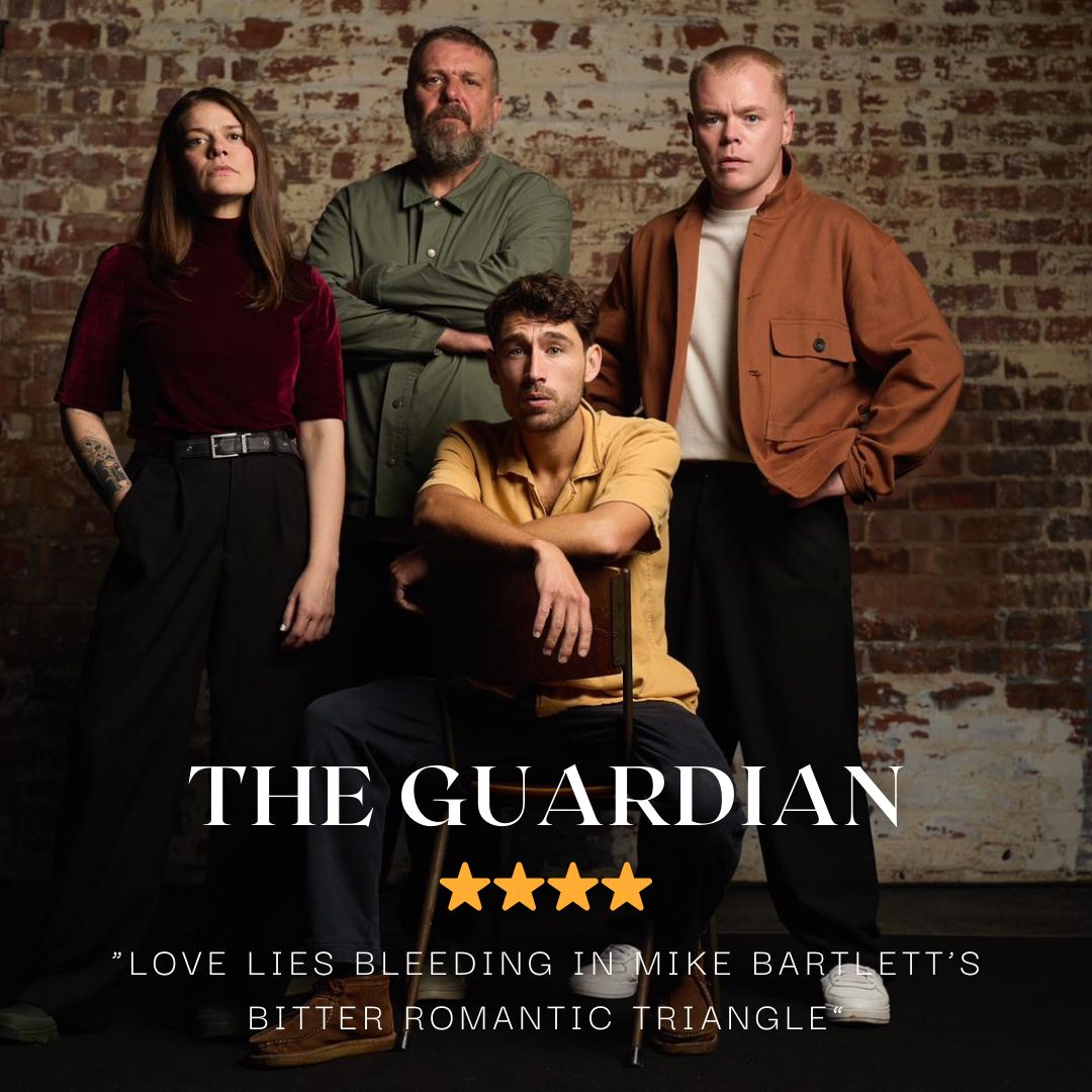 4 actor stand in the image, they all look out towards the camaera. On the left is a woman with long brown hair wearing a brown jumper and black jeans. To her left is a middle aged man with short grey hair and a grey beard. He wears a green shirt and folds his arms. Sitting in front of him on a chair is another younger man with a short sleeved yellow top. He has short back hair, his arms are draped over the back of the chair. To his left is a man, standing, he has an organe jacket, black trousers and white shoes. He stands with his hands on his hips looking out at the camera.