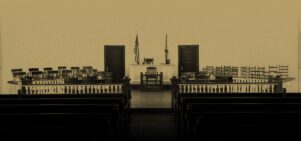 Sepia image of a courtroom with the words 'Harper Lee's To Kill A Mockingbird’