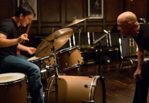 An iconic scene from the film Whiplash; Terence Fletcher aproaches Andrew Neiman menacingly as he plays the drums