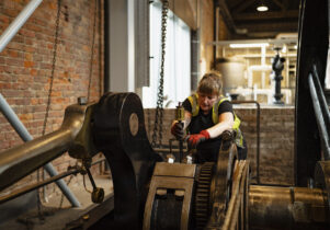 Museum technician with engine in Power Hall
