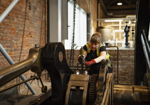 Museum technician with engine in Power Hall