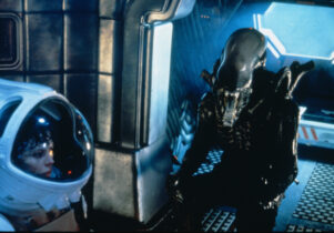 Boy in space suit looking at alien.