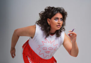 A woman poses as if she's about to start a race.