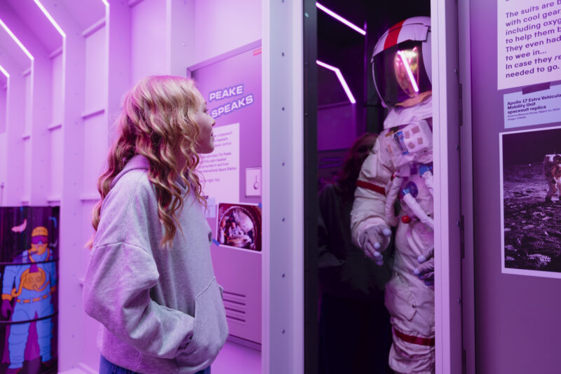 Girl looking at a Space suit in Horrible Science: Cosmic Chaos