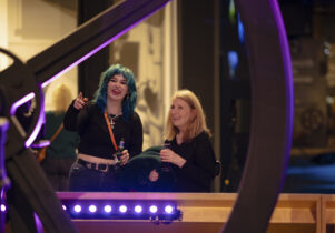 Adults looking at Revolution Manchester display