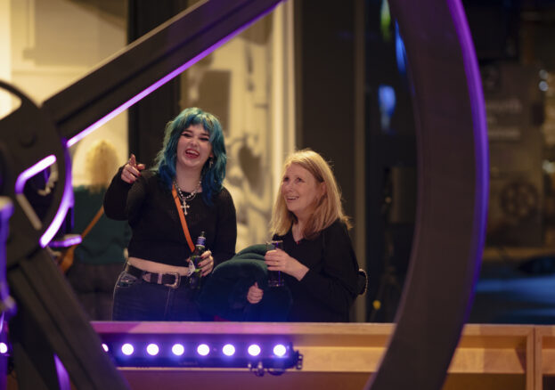 Adults looking at Revolution Manchester display