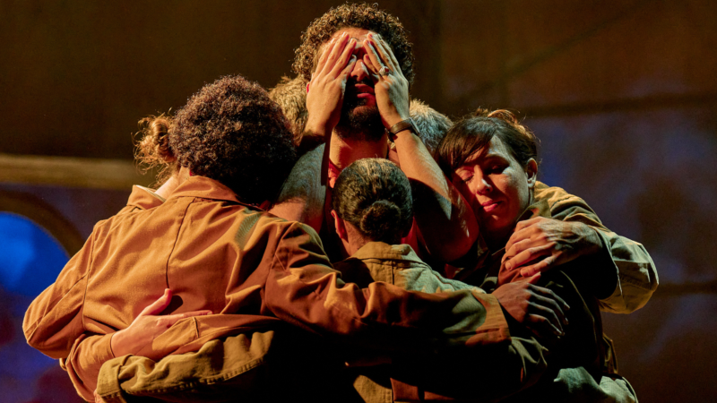 Four actors performing on stage. 