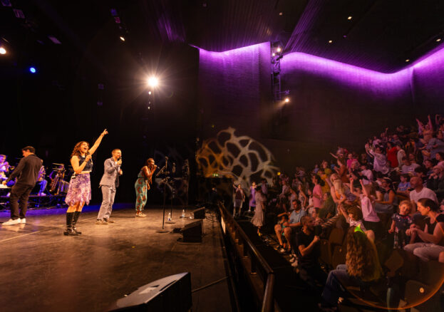 Singers engaging with crowd in theatre