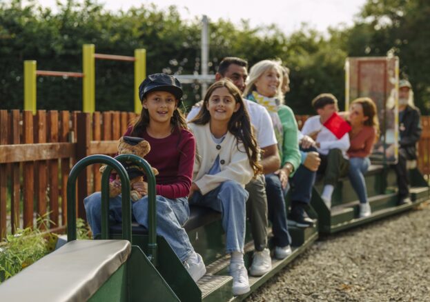 Family enjoying a mini train ride similar to the one popping up at SIM
