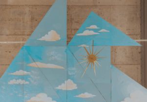 Blue triangles with white clouds on them against a beige backdrop. A gold sun is in the middle.