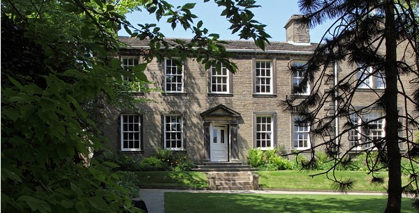 The Bronte Parsonage Museum front, with a green lawn