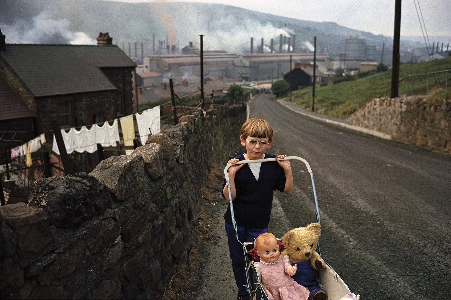 Photo of a young boy pushing a pram