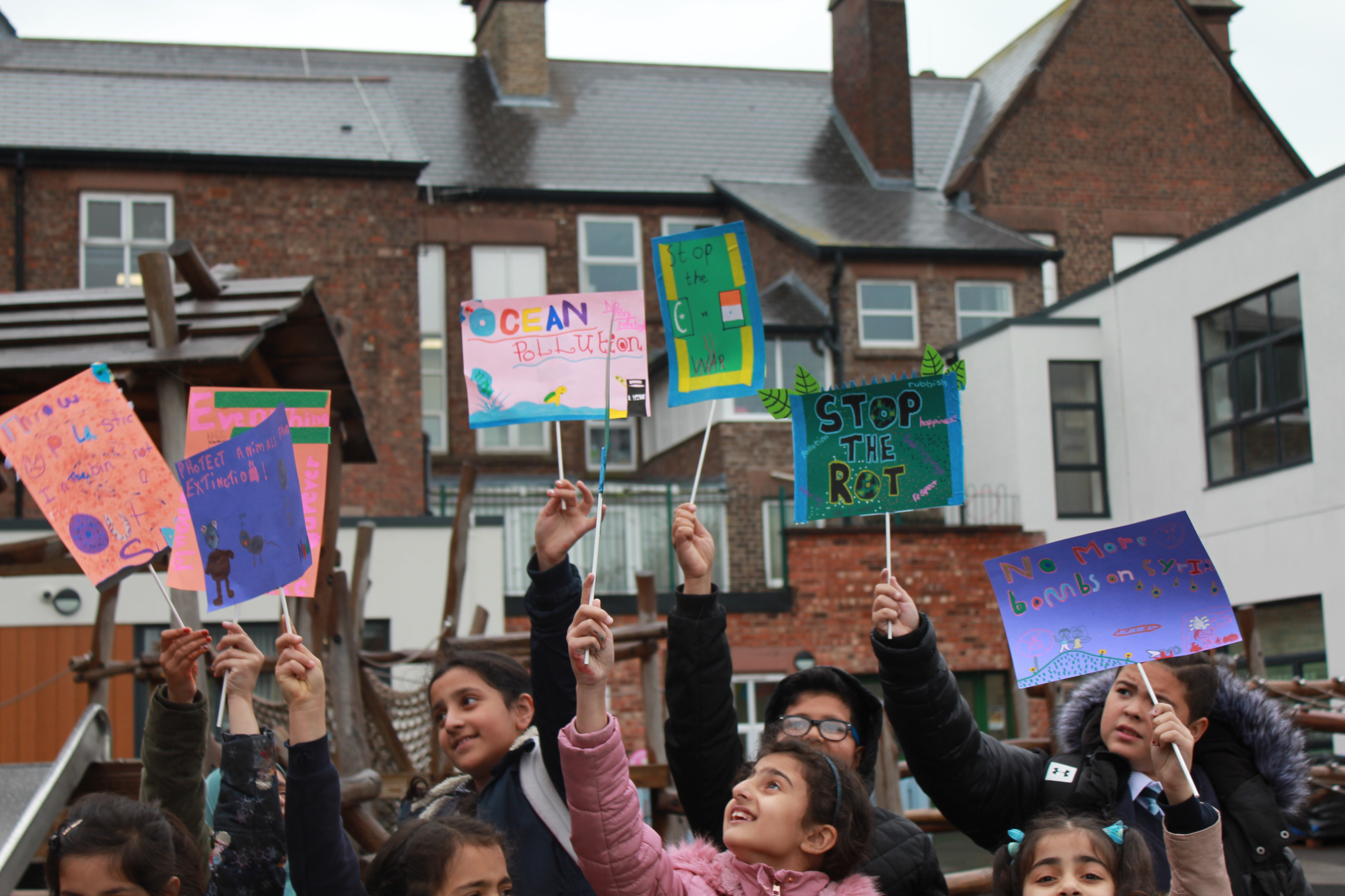 Children protesting with placards, made in a family workshop