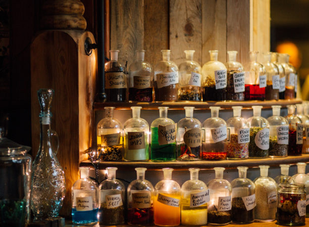 Grimm & Co Takeover event - bottles of various colours shown on shelves. They look like magical potions! 