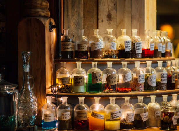 Grimm & Co Takeover event - bottles of various colours shown on shelves. They look like magical potions!
